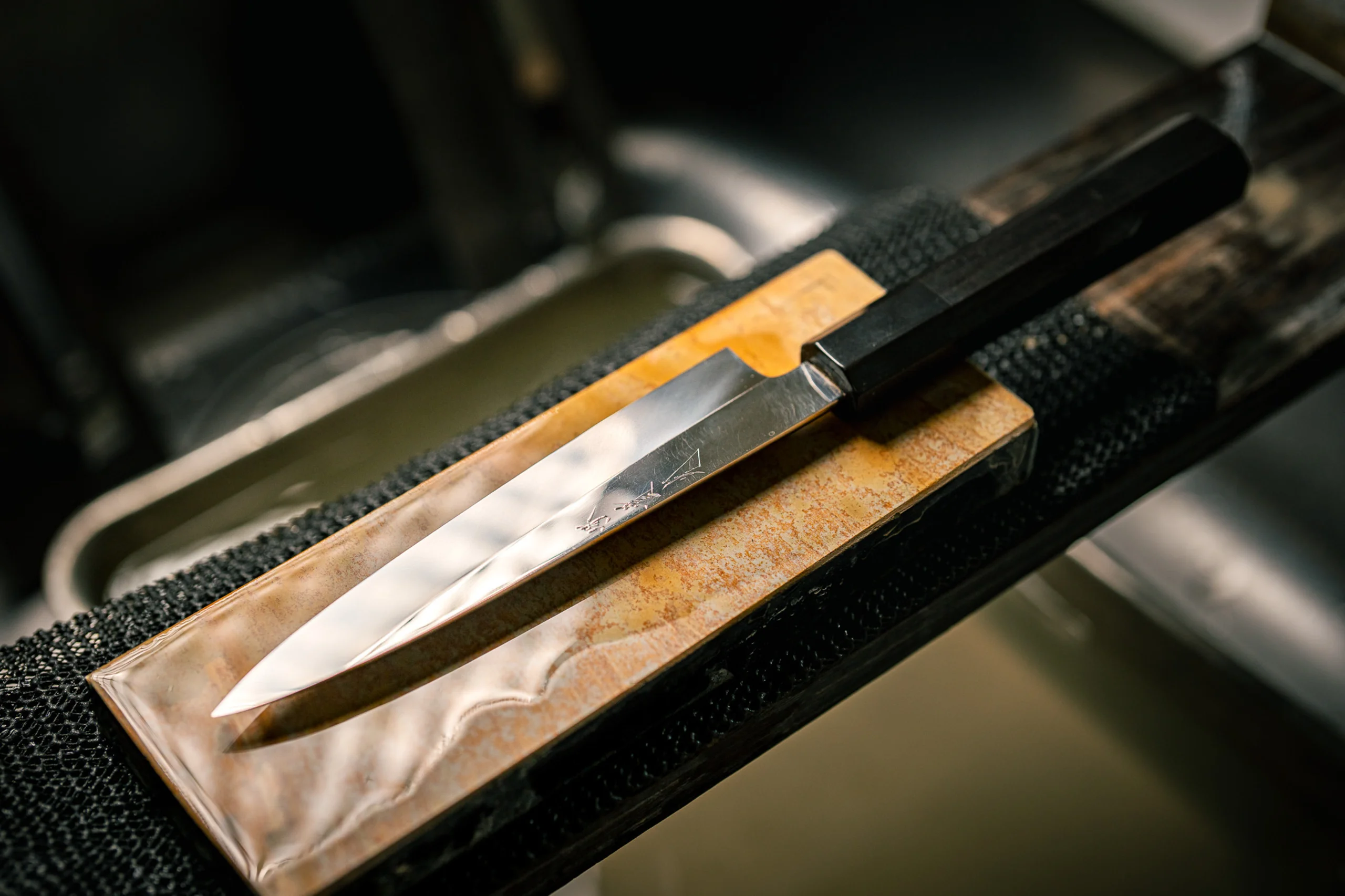A sharpened knife resting on a whetstone
